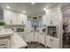 Bright kitchen featuring white shaker cabinets, quartz countertops, and recessed lighting at 17009 S 30Th Way, Phoenix, AZ 85048