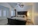 Main bedroom features a king-size bed, bay window with shutters, and ceiling fan at 17009 S 30Th Way, Phoenix, AZ 85048