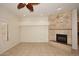 Living room with fireplace, tile floors, and window shutters at 17020 E Kiwanis Dr # 102, Fountain Hills, AZ 85268