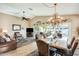 Bright dining room features a large wooden table and access to backyard patio at 17129 N Silver Path, Surprise, AZ 85374