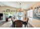 Spacious dining area with a large table, chandelier, and artwork at 17129 N Silver Path, Surprise, AZ 85374