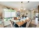 Elegant dining room with a wooden table, chandelier, and artwork at 17129 N Silver Path, Surprise, AZ 85374