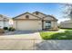 Single-story house with a two-car garage and well-maintained lawn at 17129 N Silver Path, Surprise, AZ 85374