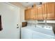 Laundry room with washer, dryer, and upper cabinets at 17129 N Silver Path, Surprise, AZ 85374