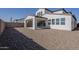 Backyard featuring a covered patio and a large gravel space, ideal for low-maintenance living at 17219 W Vacaville St, Surprise, AZ 85388