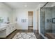 Beautiful bathroom featuring dual vanities, large glass shower, and a walk-in closet at 17219 W Vacaville St, Surprise, AZ 85388