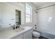 Bright bathroom featuring a shower-tub, a white vanity, and a large mirror at 17219 W Vacaville St, Surprise, AZ 85388