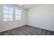 Spare bedroom with carpet, two windows, and light gray walls at 17219 W Vacaville St, Surprise, AZ 85388