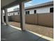 Covered patio and gravel backyard with block wall at 17380 W Carlisle Dr, Surprise, AZ 85388