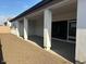 Covered patio and gravel backyard with block wall at 17380 W Carlisle Dr, Surprise, AZ 85388