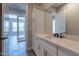 Bathroom boasts a white vanity with matte black fixtures and a large mirror at 17380 W Carlisle Dr, Surprise, AZ 85388