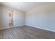 Light and airy bedroom with wood-look tile floors at 17380 W Carlisle Dr, Surprise, AZ 85388