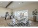 Dining area with a large table and chairs, seamlessly connected to the living area and patio via sliding glass door at 17380 W Carlisle Dr, Surprise, AZ 85388