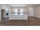 Modern kitchen island with white shaker cabinets and quartz countertops at 17380 W Carlisle Dr, Surprise, AZ 85388