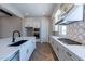 Modern kitchen with white cabinets, gas cooktop, and patterned backsplash at 17380 W Carlisle Dr, Surprise, AZ 85388