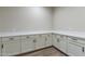 Spacious laundry room with white cabinets and ample counter space at 17380 W Carlisle Dr, Surprise, AZ 85388