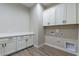 Laundry room with white cabinets and countertop at 17380 W Carlisle Dr, Surprise, AZ 85388