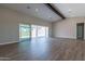 Spacious living room with sliding glass doors and wood-look floors at 17380 W Carlisle Dr, Surprise, AZ 85388