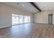 Bright living room with hardwood floors and sliding glass doors leading to backyard at 17380 W Carlisle Dr, Surprise, AZ 85388