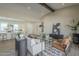 Bright and open living room with stylish furnishings, a vaulted ceiling, and seamless flow into the kitchen at 17380 W Carlisle Dr, Surprise, AZ 85388