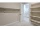 A walk-in closet provides shelving for storage and entry to the bathroom at 17380 W Carlisle Dr, Surprise, AZ 85388