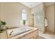 Relaxing bathroom with large soaking tub and glass block shower at 17459 N 79Th St, Scottsdale, AZ 85255