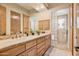 Clean bathroom with double vanities, glass block shower, and ample storage at 17459 N 79Th St, Scottsdale, AZ 85255