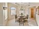 Formal dining room with a wooden table and chandelier, bathed in natural light at 17459 N 79Th St, Scottsdale, AZ 85255