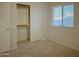 Bedroom with closet, window, and carpeted floors at 1933 S Peppertree Dr, Gilbert, AZ 85295