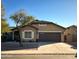 Tan house with brown garage door and landscaping at 1933 S Peppertree Dr, Gilbert, AZ 85295