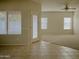 Living room with tile and carpet flooring and view to backyard at 1933 S Peppertree Dr, Gilbert, AZ 85295