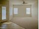 Living room with carpet and tile flooring, plus a door to patio at 1933 S Peppertree Dr, Gilbert, AZ 85295