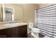 Clean bathroom with dark vanity, shower/tub combo, and striped curtain at 1940 N 78Th Gln, Phoenix, AZ 85035