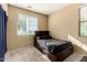 Small bedroom with a twin-sized bed and plenty of natural light at 1940 N 78Th Gln, Phoenix, AZ 85035