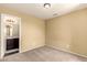 Bright bedroom with ensuite bathroom access and neutral carpeting at 1940 N 78Th Gln, Phoenix, AZ 85035