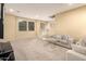 Living room with grey sofas, a glass table, and a large TV at 1940 N 78Th Gln, Phoenix, AZ 85035