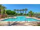 Community pool with multiple areas for swimming and lounging at 1940 N 78Th Gln, Phoenix, AZ 85035