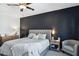 Main bedroom with king bed, dark accent wall, ceiling fan and ample natural light at 20838 W Granada Rd, Buckeye, AZ 85396