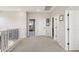 Upstairs hallway with carpet, neutral walls and doors to bedrooms and bathroom at 20838 W Granada Rd, Buckeye, AZ 85396