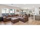 Open concept living and dining area with brown sectional sofa at 20838 W Granada Rd, Buckeye, AZ 85396