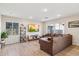 Spacious living room with brown sectional sofa and large TV at 20838 W Granada Rd, Buckeye, AZ 85396