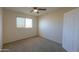 Well-lit bedroom with carpeted floors and window at 21404 N Van Loo Dr, Maricopa, AZ 85138