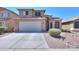 Two-story house with solar panels and a two-car garage at 21404 N Van Loo Dr, Maricopa, AZ 85138