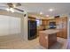 Kitchen features island, stainless steel appliances, and wood cabinets at 21404 N Van Loo Dr, Maricopa, AZ 85138