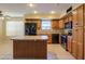 Kitchen with island, stainless steel appliances, and wood cabinets at 21404 N Van Loo Dr, Maricopa, AZ 85138