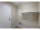 Laundry room with washer/dryer hookups and shelving at 21404 N Van Loo Dr, Maricopa, AZ 85138