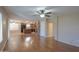 Living room with wood floors, ceiling fan, and kitchen view at 21404 N Van Loo Dr, Maricopa, AZ 85138