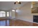 Living room with hardwood floors, ceiling fan, and arched windows at 21404 N Van Loo Dr, Maricopa, AZ 85138