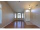 Living room with hardwood floors, ceiling fan, and arched windows at 21404 N Van Loo Dr, Maricopa, AZ 85138