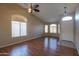 Living room with hardwood floors, ceiling fan, and arched windows at 21404 N Van Loo Dr, Maricopa, AZ 85138